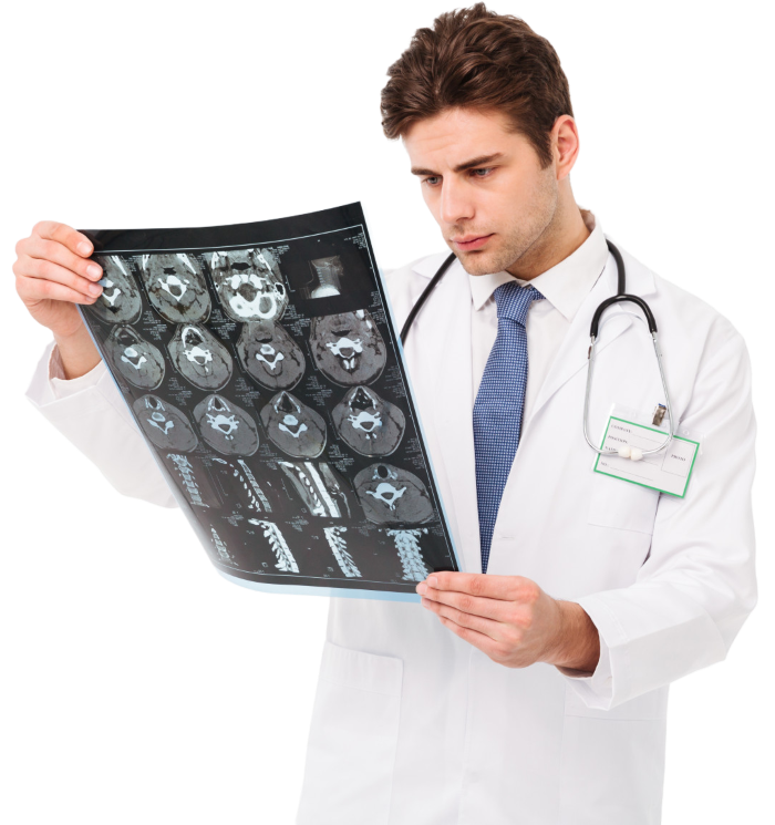 A male doctor wearing a stethoscope and examining a medical scan film.